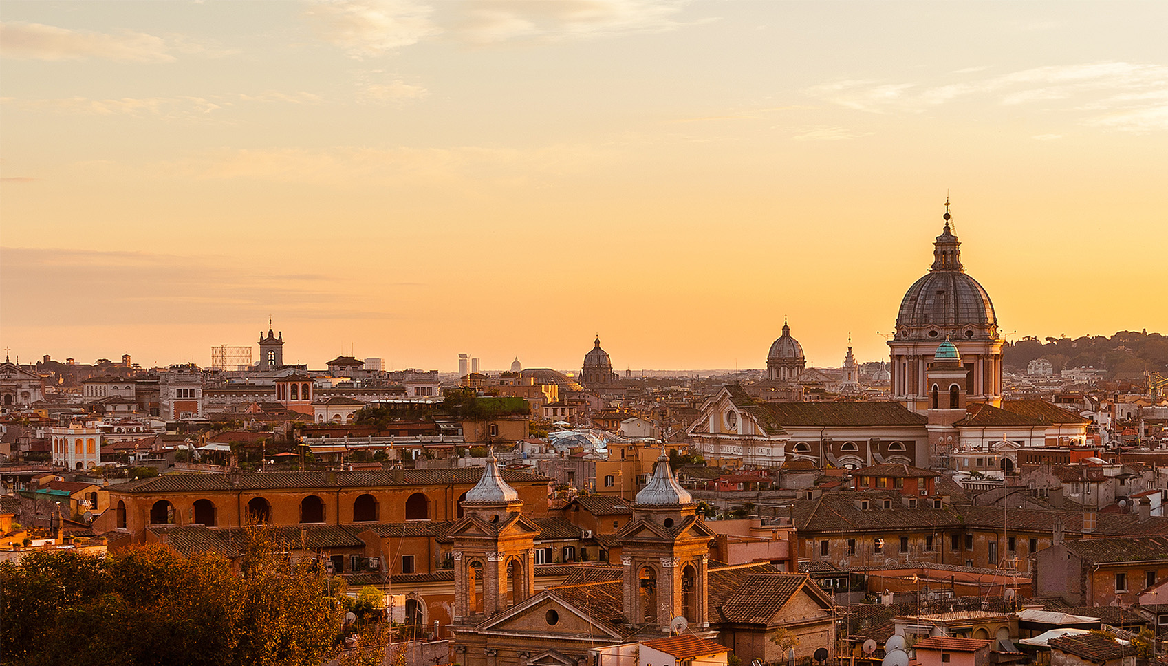 View of Rome from the top of the building while the sun is setting.